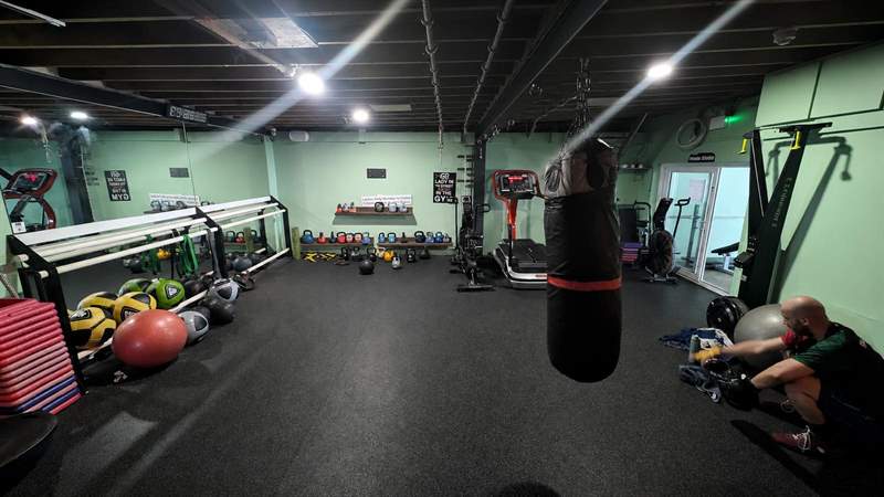 The studio: punchbag, kettlebells, medicine balls, treadmill, mats and the private studio door.